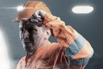 portrait of tired rail worker with orange unifom and helmet light in front of tunnel - obrazy, fototapety, plakaty