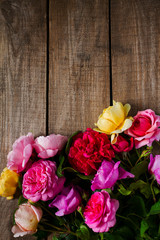 various roses on wooden surface
