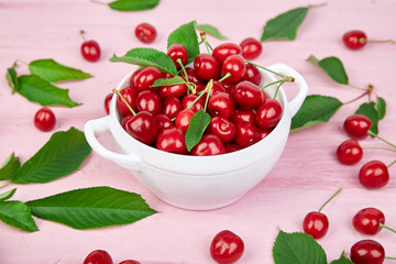 Red cherry in white bowl