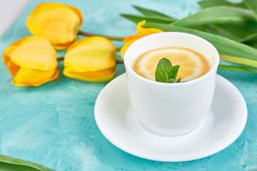 White cup of tea with lemon