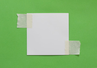 pieces of torn paper on green background. copy space