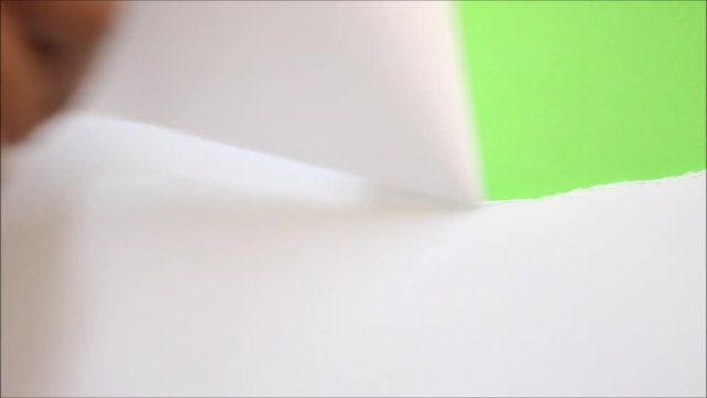 Tearing white paper into torn green screen background