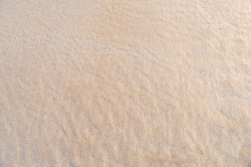 Wet sand beach texture for background