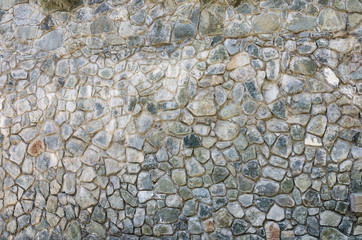 Texture of an old stone wall. Fragment of an old park stone fence