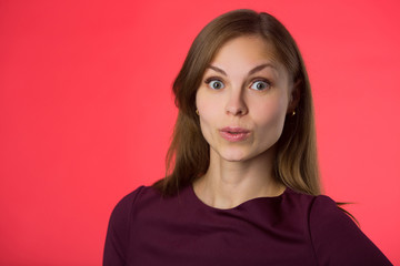 Fototapeta premium beautiful young girl with her hair on a red background