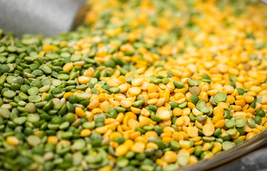 Macroshot of green and yellow mixed lentils, sale on local city market