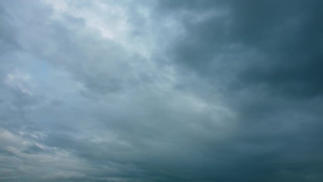 Storm and rain clouds formation in the sky. Clouds moving fast timelapse.