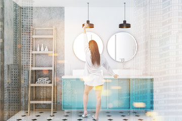 Double vessel sink in blue bathroom, shelves, girl