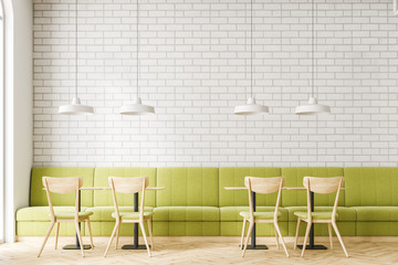 Loft white brick restaurant interior, green sofa
