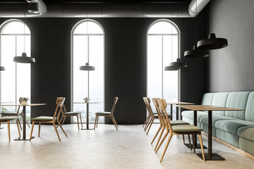 Arched windows restaurant interior, green sofas