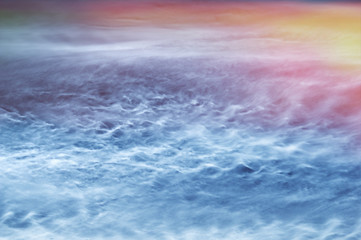 Fototapeta premium Night cloudy sky illuminated by the sunrise background