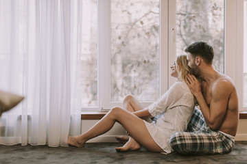 Loving couple sitting on the floor in the room