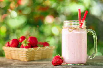strawberry milkshake in mason jar on table