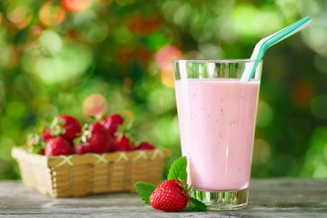 strawberry milkshake in glass on table