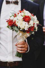 A groom with wedding bouquet, closeup