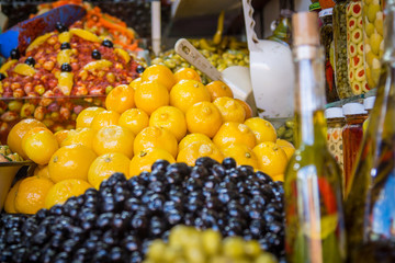 Olives and various spicy pickles in a large bowl on the shelves at the market in Marrakesh. Morocco. Africa