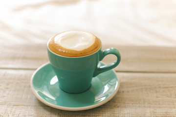 Hot coffee cappuccino isolated on wooden table
