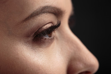 Closeup macro photo of woman's eyes with long lashes and natural makeup