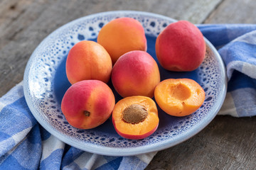 Ripe sweet fresh apricots on a plate.