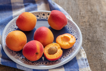 Naklejka na ściany i meble Juicy delicious ripe apricots on a plate.