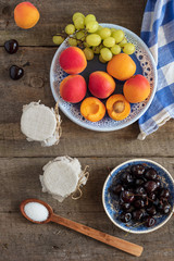 Fresh fruits with homemade jam on wooden table. Top view. Rustic style.