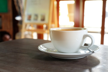 coffee in white cup and smoke. hot coffee in cafe and light.