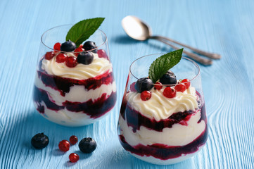 Berry mascarpone mousse dessert, on blue background.