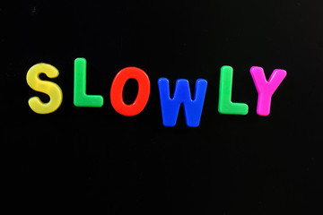 English letters in black background are the words slowly