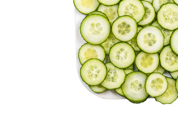 Cucumber slices on white marble board, isolated on white