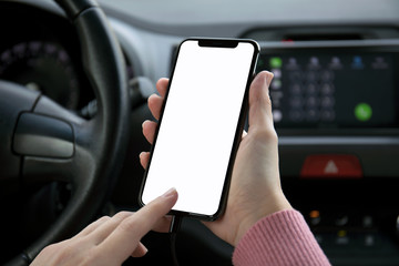 women hand holding phone with isolated screen in the car