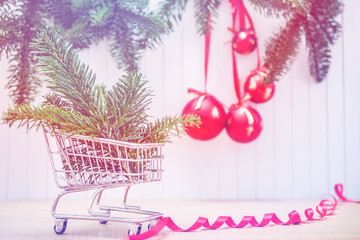 christmas gift in shopping cart. Xmas gifts on wooden background. christmas presents with Fir tree branches. Xmas greeting card and border with copy space