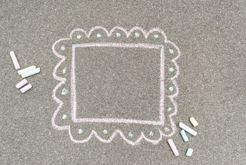 Pieces of chalk and a painted frame on a dark background