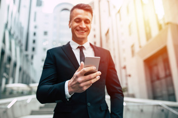 Business man using mobile phone outdoors