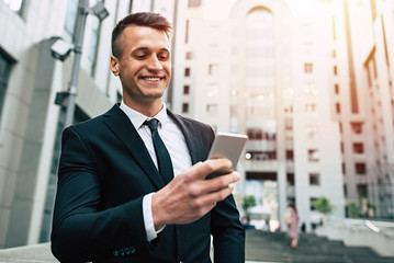Business man using mobile phone outdoors