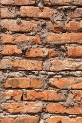 close-up of brickwork and cement, background of an old vintage dirty brick wall with peeling, texture