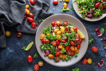 Fresh Cherry Tomato mix salad with lettuce, lemon, lime, black pepper and sea salt. healthy food