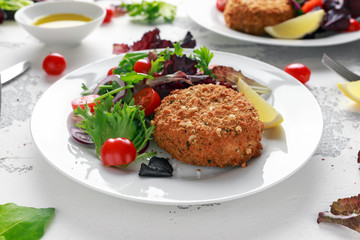 Home made Fish Cake salmon, spinach and potato. served on plate with vegetables