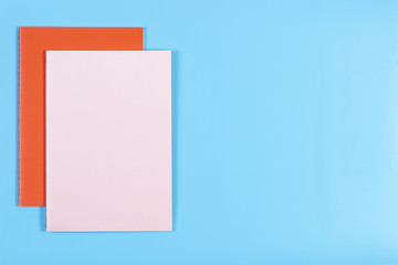 Colorful notebooks on blue background