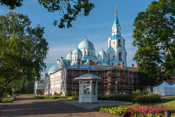 Fototapeta na wymiar Spaso-Preobrazhensky Cathedral surrounded by cell buildings. Valaam is a cozy and quiet piece of land, the rocky shores of which rise above the lush waters of lake Ladoga