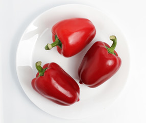 Red pepper on the plate. white background. 