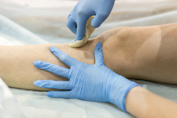 process of legs depilation by sugar for women in beauty salon