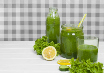 Smoothies. Green cocktail with vegetables and lemon.