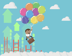 African businessman holding balloons up in the sky , success concept