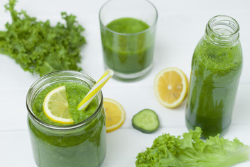  Vegetarian cocktail. Green smoothies with vegetables, herbs and lemon on a white background. Healthy eating.