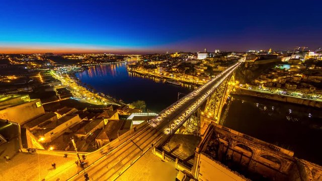 Time-lapse view on the illuminated Old Town and the iconic Dom Luis Bridge at the River Duro in Porto during sunset
