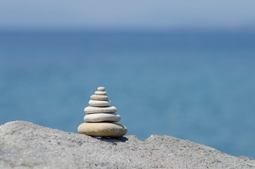 Fototapeta na wymiar Stones balance inspiration wellness concept. Harmony on the coast of the Sea.