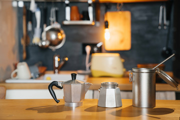 Making coffee on a wooden table using a geyser coffee machine.