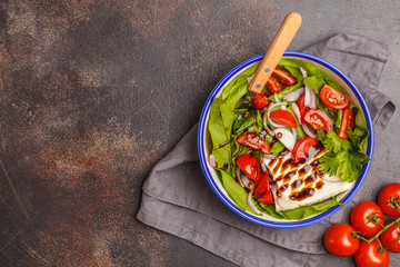 Bright summer salad with goat cheese feta, tomato, red onion and balsamic on a white background, copy space