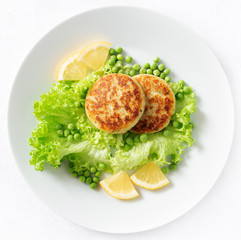 fried cod cutlets with lettuce, pea, and lemon