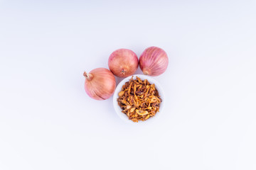 Deep fried shallots crisp / fried crispy onion flakes  (bawang goreng) in white bowl over wooden...